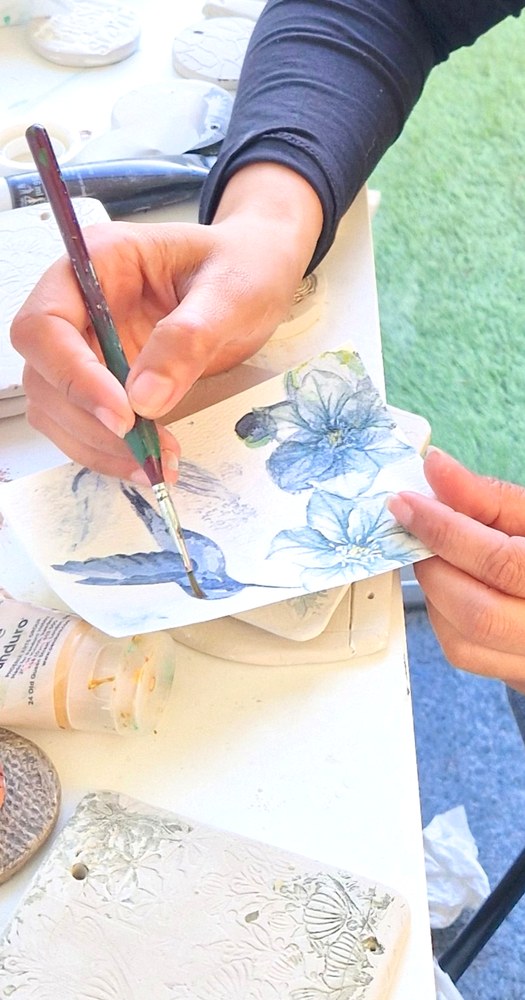 Hamna painting a bookmark by hand